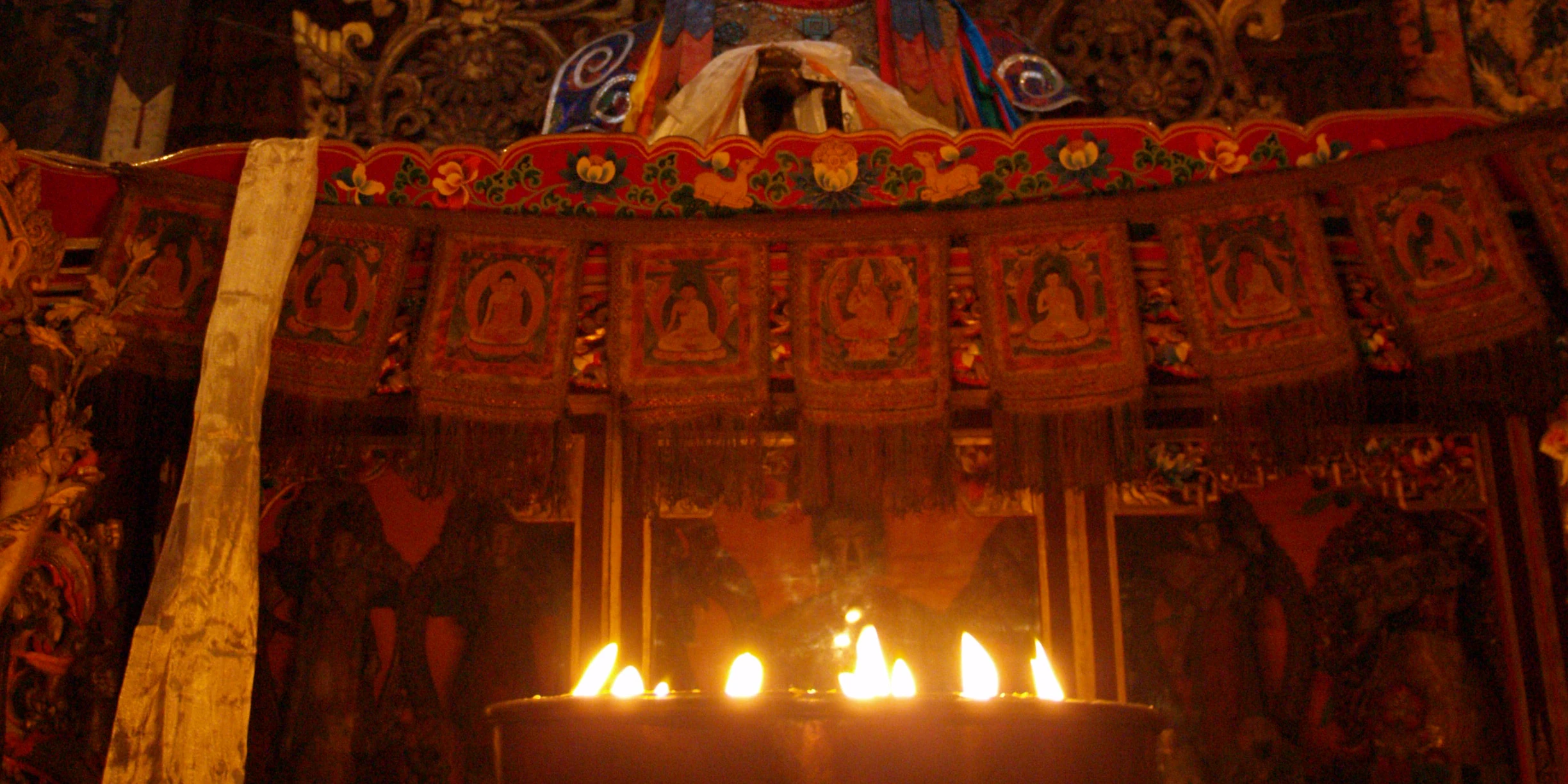 Rows of yak-butter lamps burning in the Pelkor Chode monastery in Gyantse, Tibet